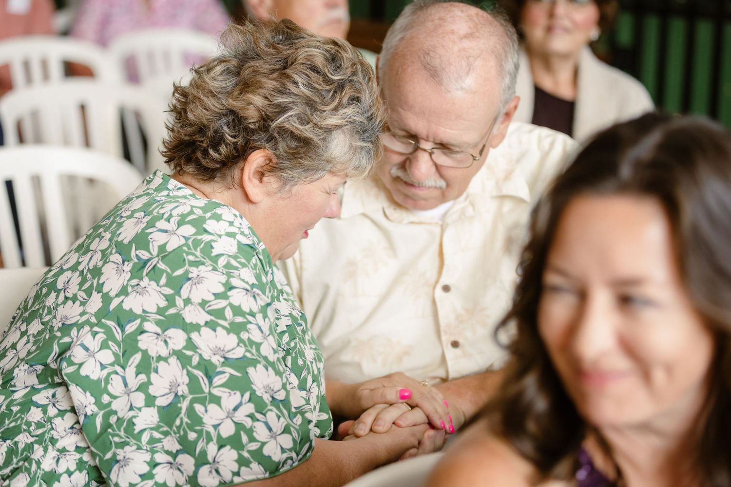 A group of people gather around a table at what appears to be a social gathering or celebration.