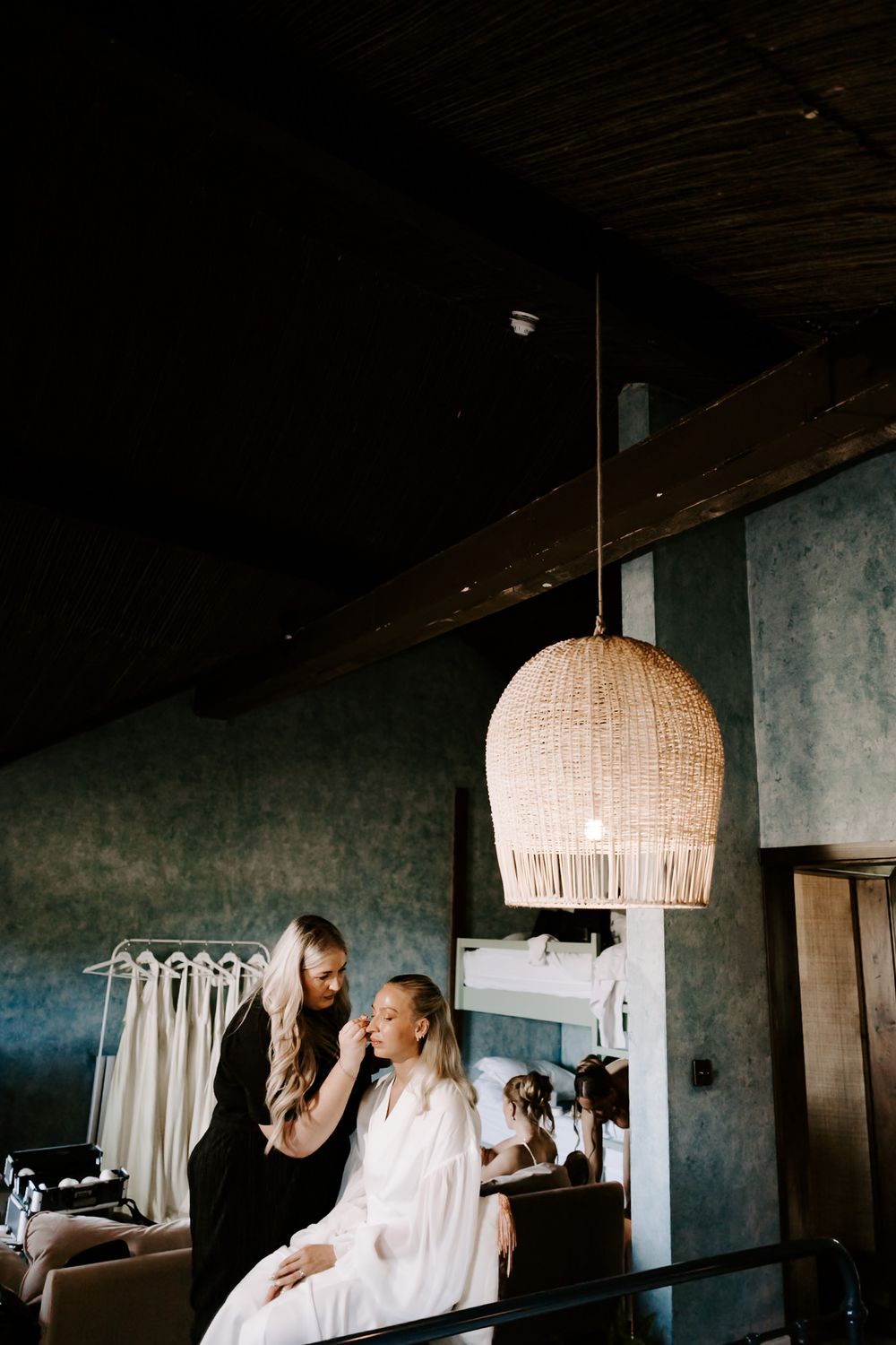 A moody sequence of interior shots with a pendant light fixture casting warm illumination in a dark room.