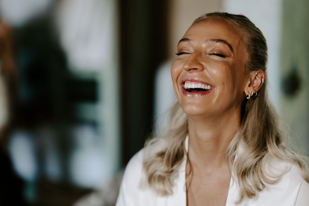 Several people sharing a genuine laugh while sitting together indoors.