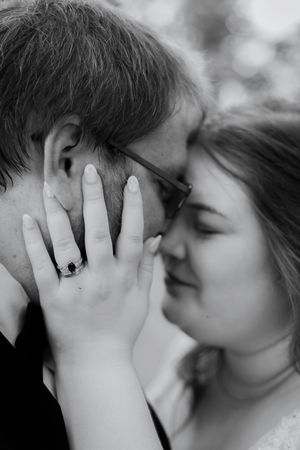 Black and white romantic close-up of couple sharing tender moment.