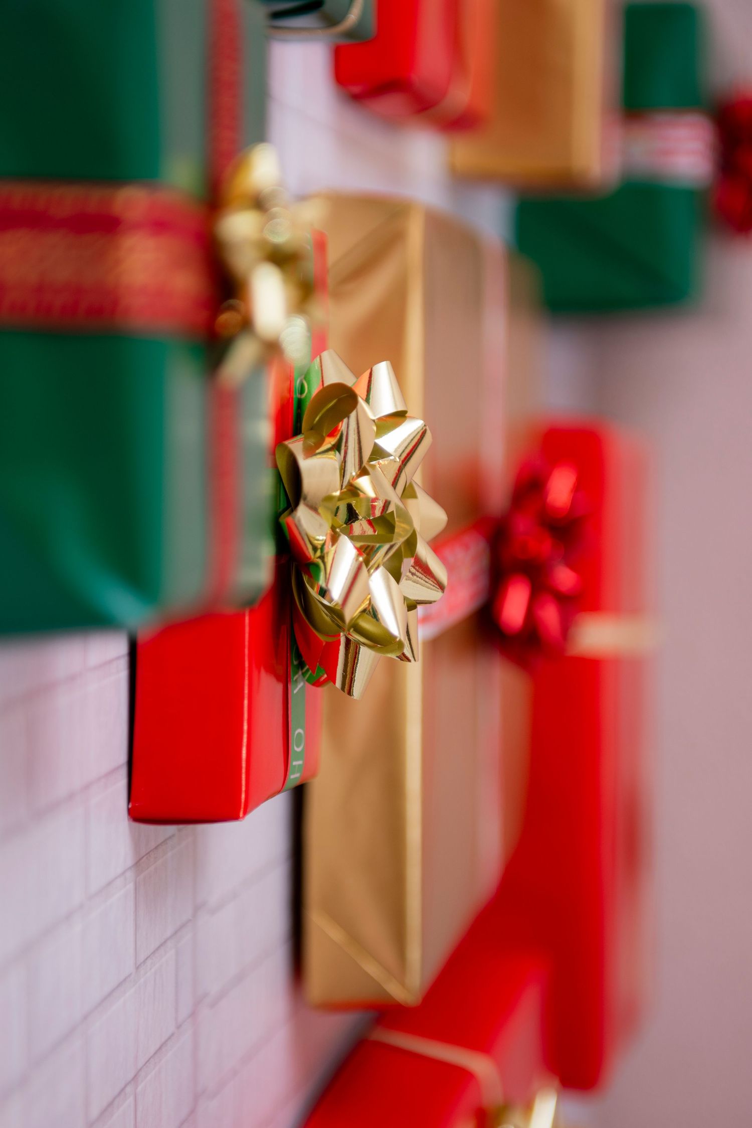 A close-up view of Christmas decorations showing gold and red gift boxes with metallic bows in a festive holiday display.