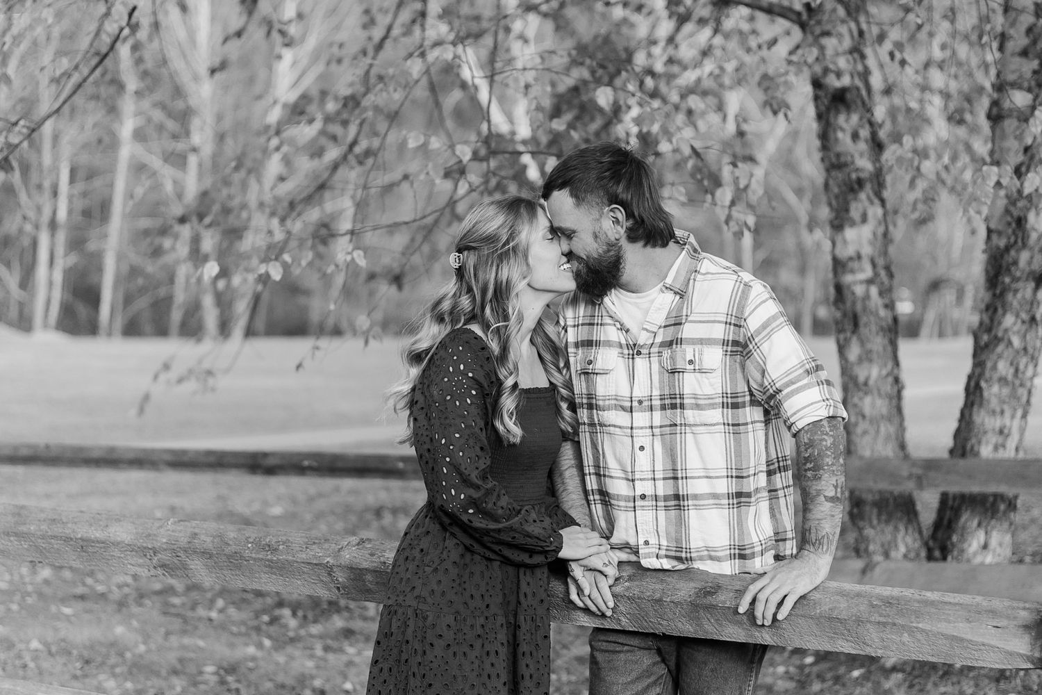 A black and white photo series showing people kissing together in a park or outdoor setting.