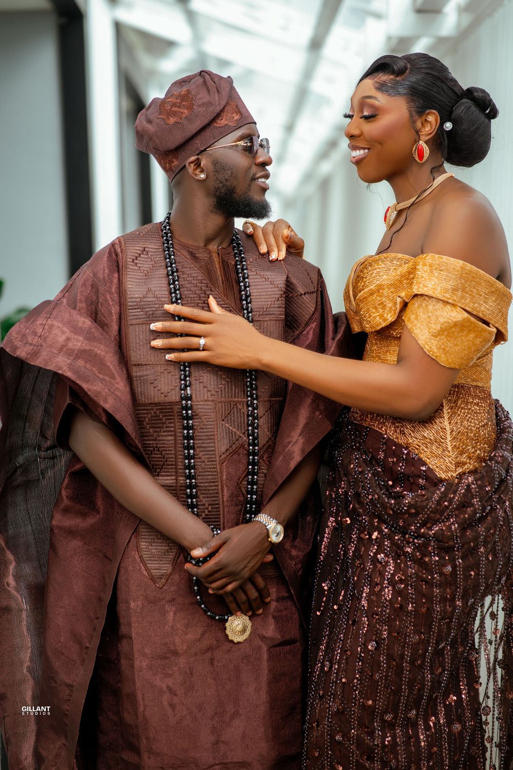 A happy couple in traditional Nigerian attire share intimate moments in a series of romantic engagement photos.
