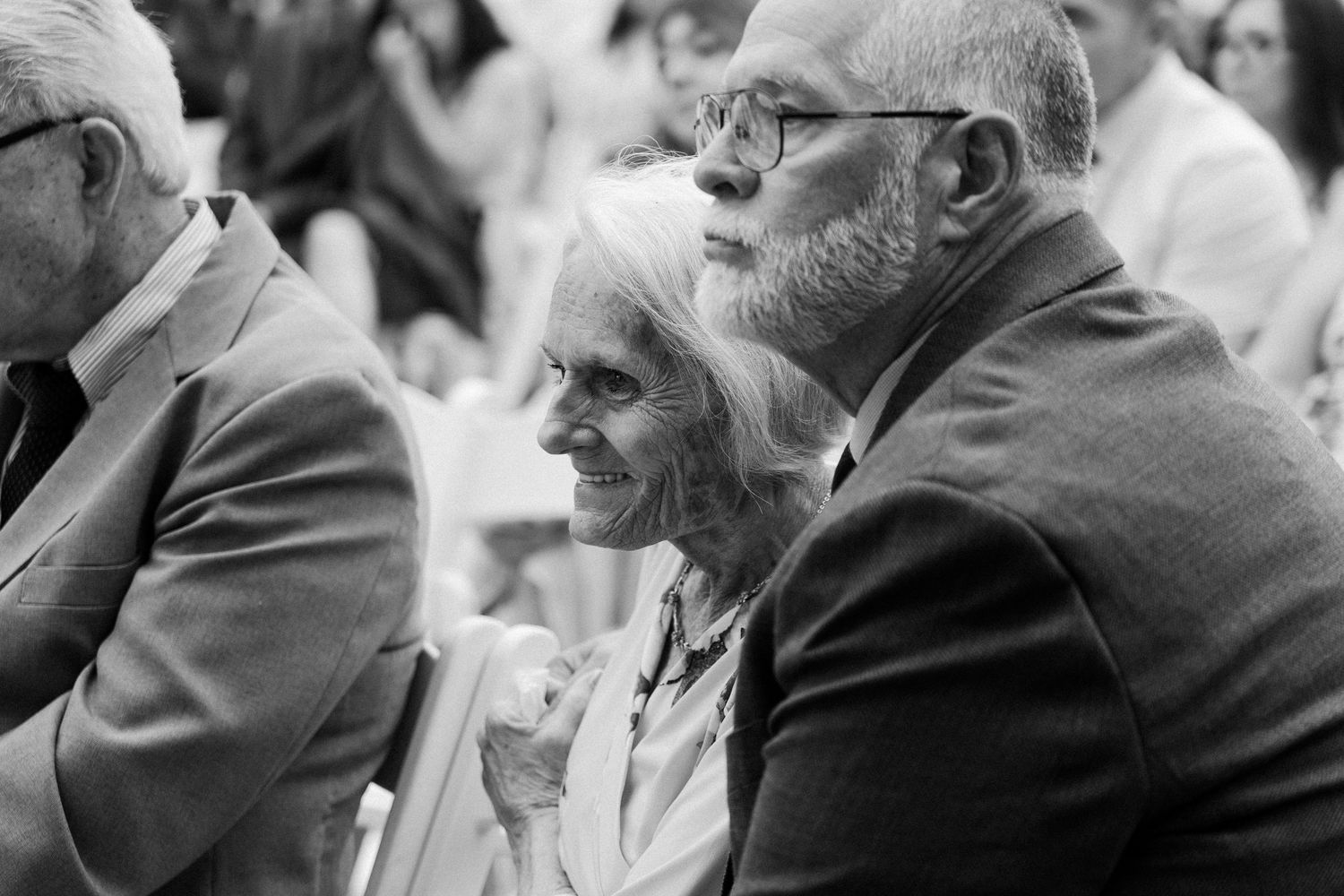 A series of black and white photographs showing elderly people in profile view engaged in conversation.