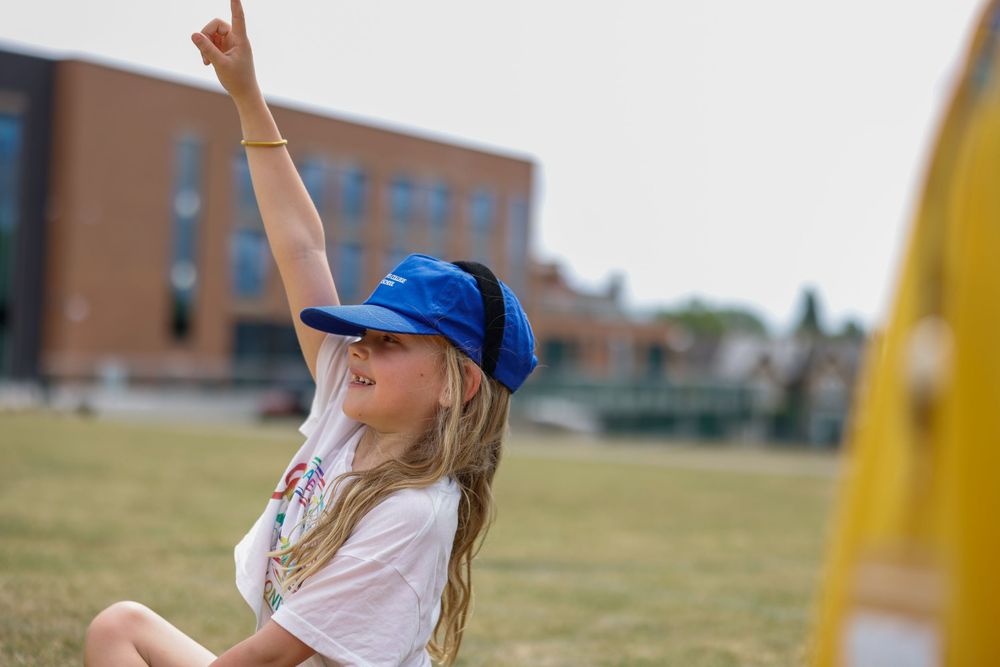 Students enjoying outdoor recreational activities on a sunny day at school.