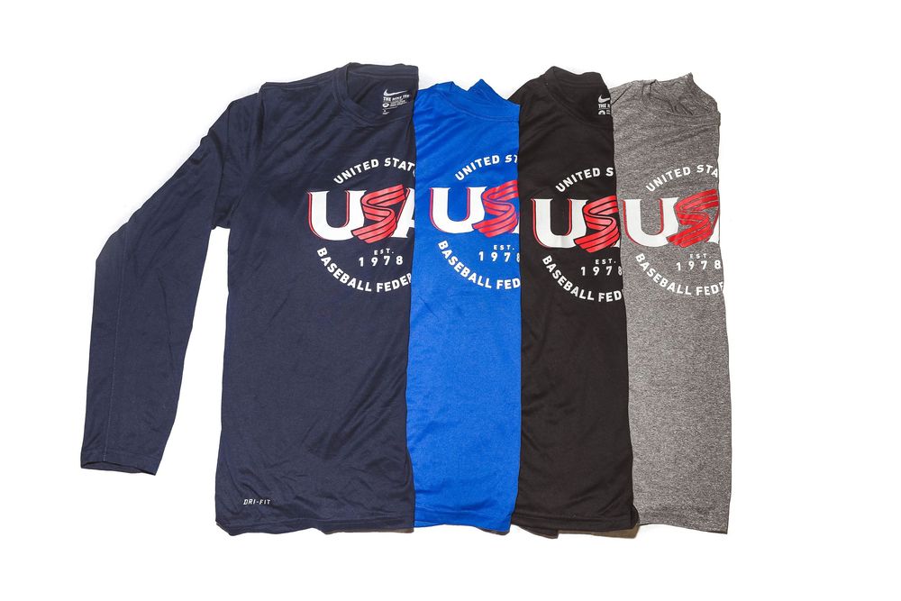 Four Nike USA Baseball Federation long-sleeve shirts in navy, blue, black, and gray.