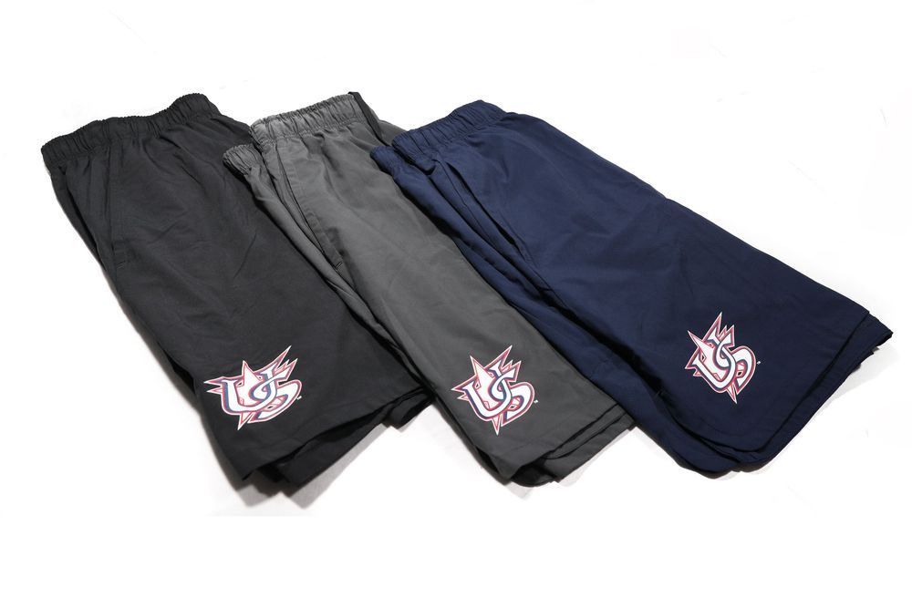 Three pairs of athletic shorts in black, gray, and navy with embroidered logo detail on left leg.