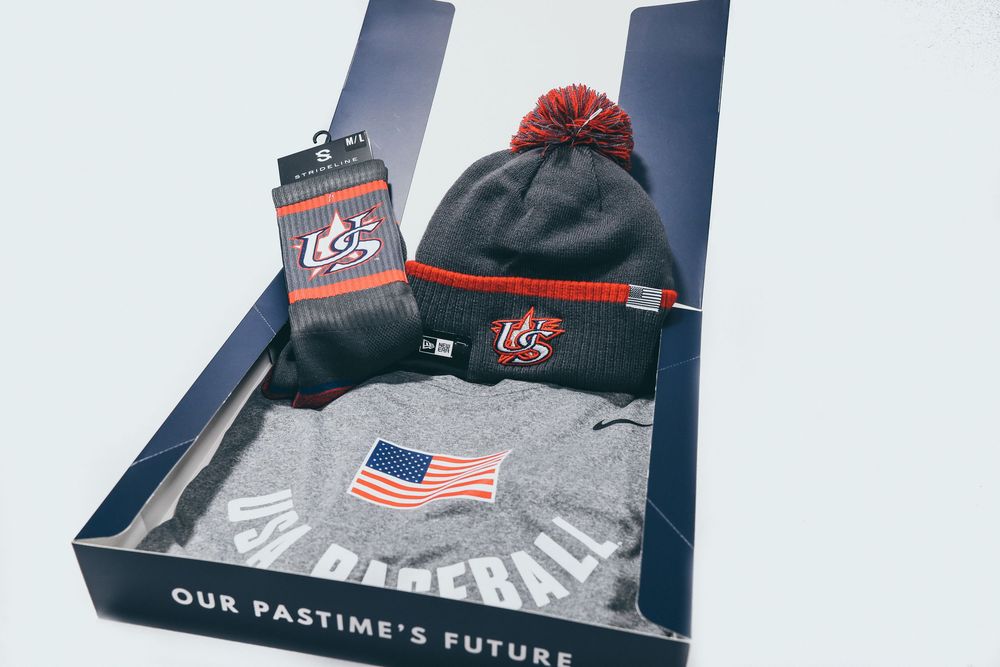 Gray USA Baseball Nike hoodie, pom beanie, and socks in Our Pastimes Future box.