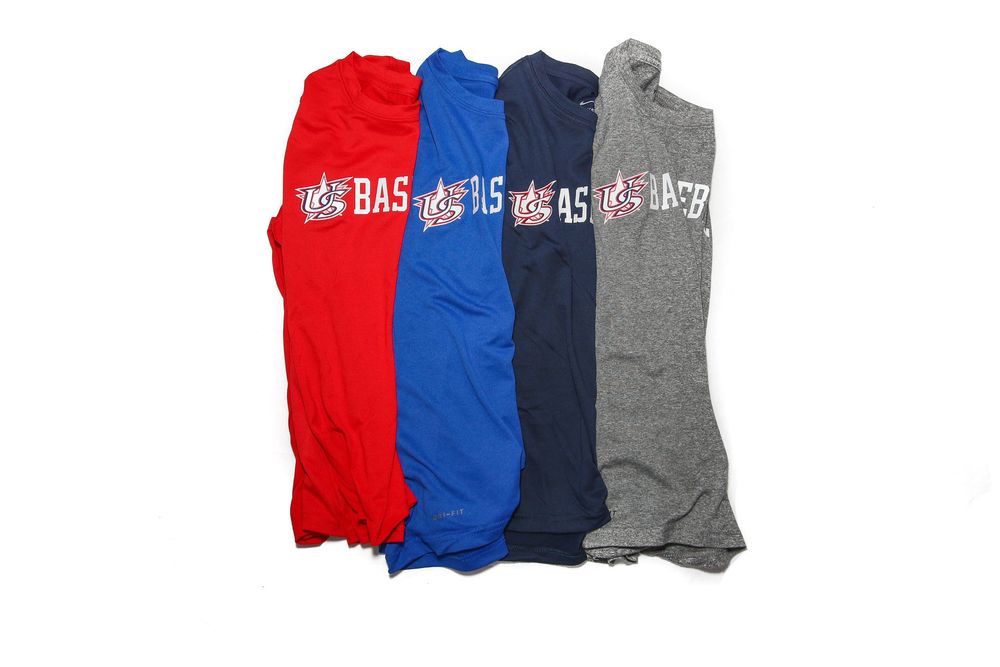 Four USA Baseball sleeveless shirts in red, blue, navy, and gray laid flat.