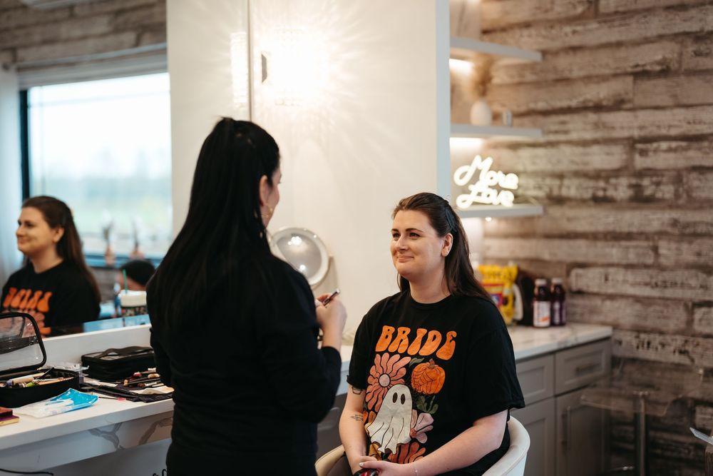 Wedding preparation scene in a modern salon with rustic wood paneled walls.
