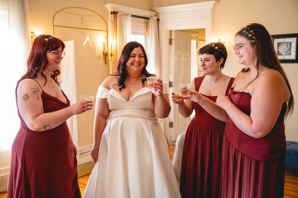 A series of wedding preparation photos showing bridesmaids in burgundy dresses helping with a white wedding gown.