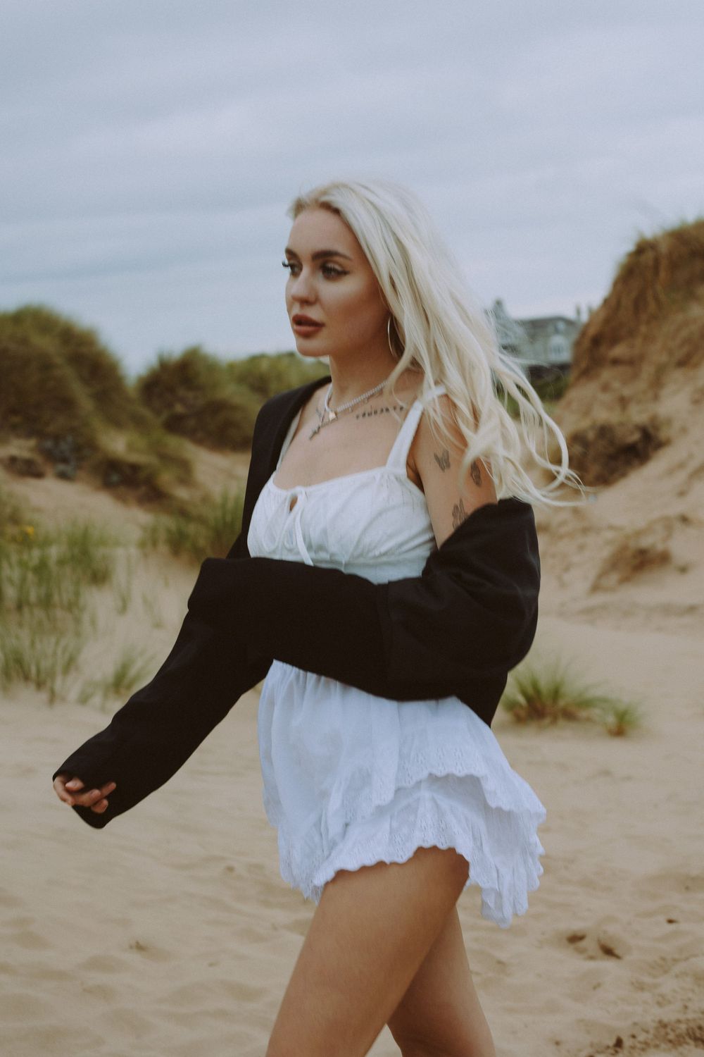 Artistic dance movements captured in a series of poses among coastal sand dunes and beach grass.