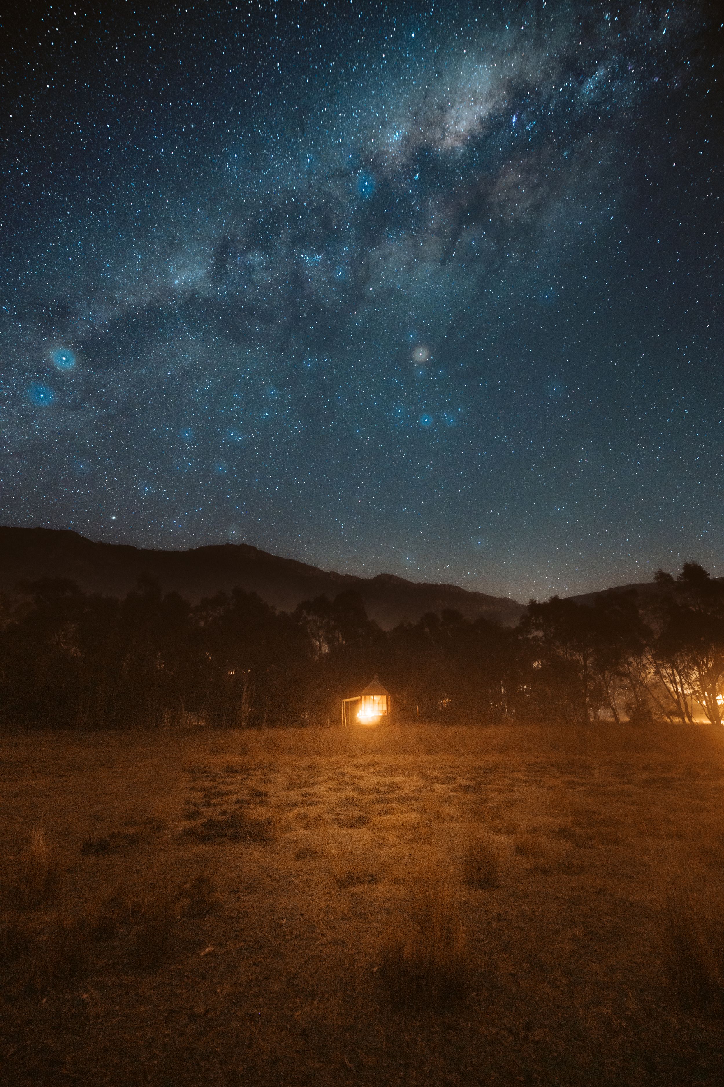 Milky Way galaxy and starry night sky over mountain silhouette in Grampians Region Victoria