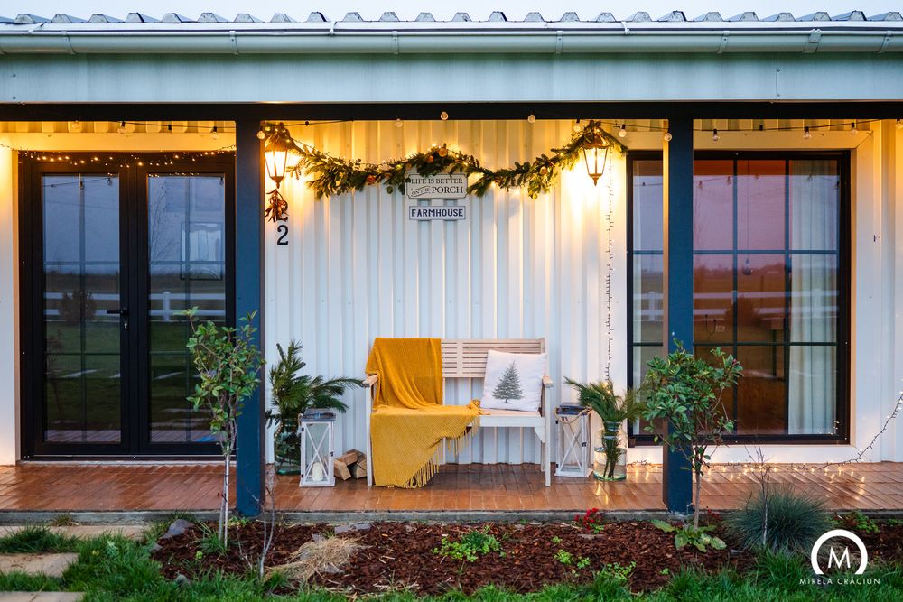 A row of white and yellow building facades with windows and awnings stretches across the exterior of a property.