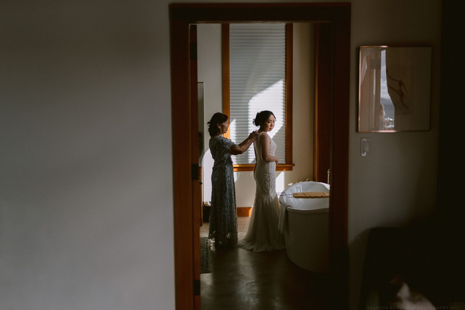 Silhouetted figures in doorways create dramatic wedding day composition.