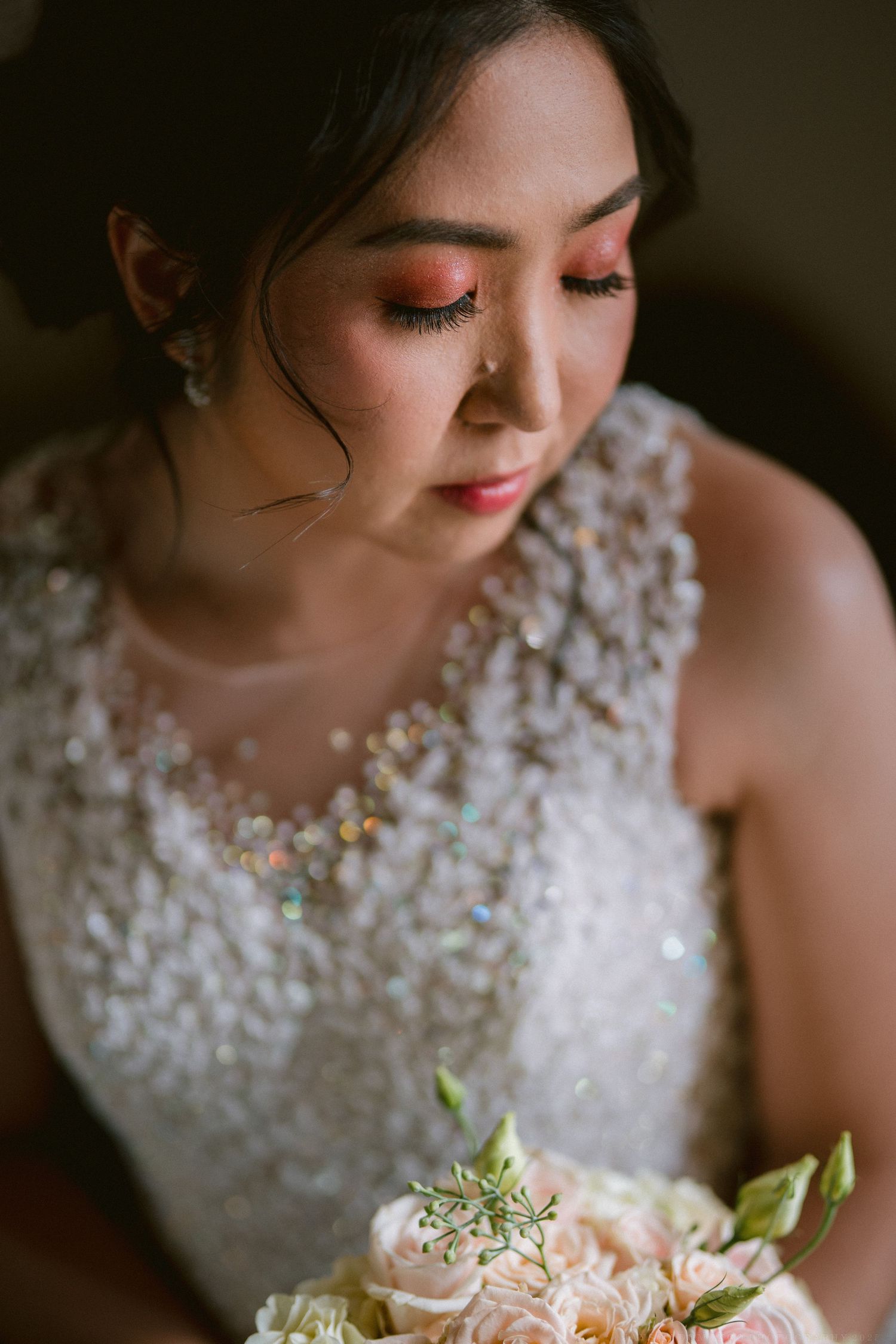Close-up details of a bridal gown with delicate lace and floral embellishments.