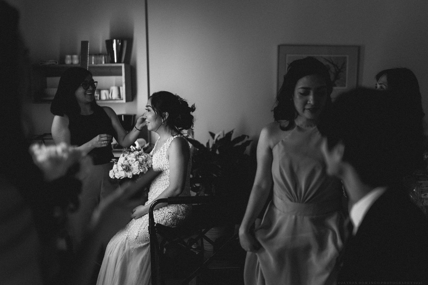 A series of black and white wedding photographs showing intimate moments between couples and guests during the celebration.