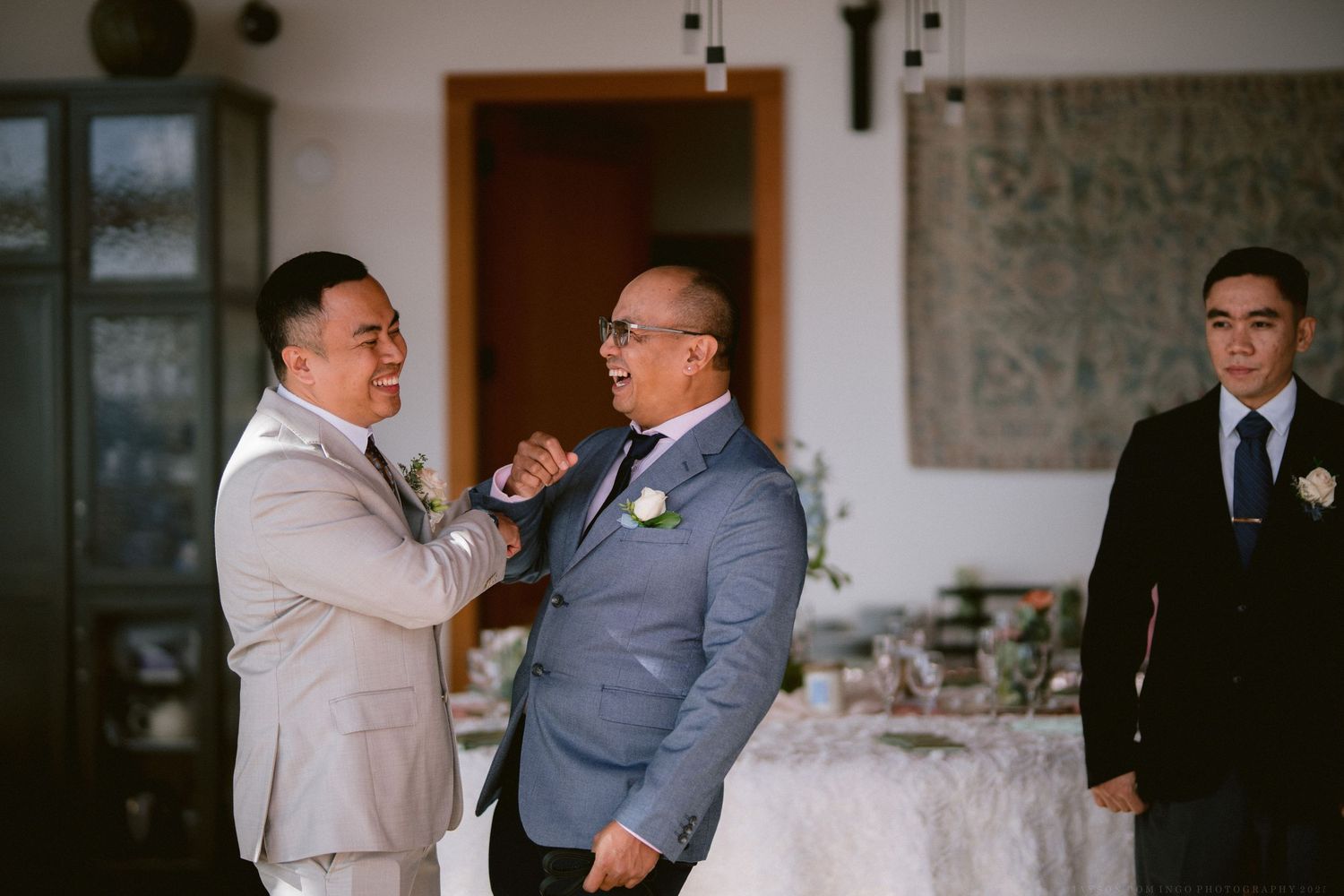 Wedding ceremony setup with formal attire and floral decorations in an elegant indoor setting.