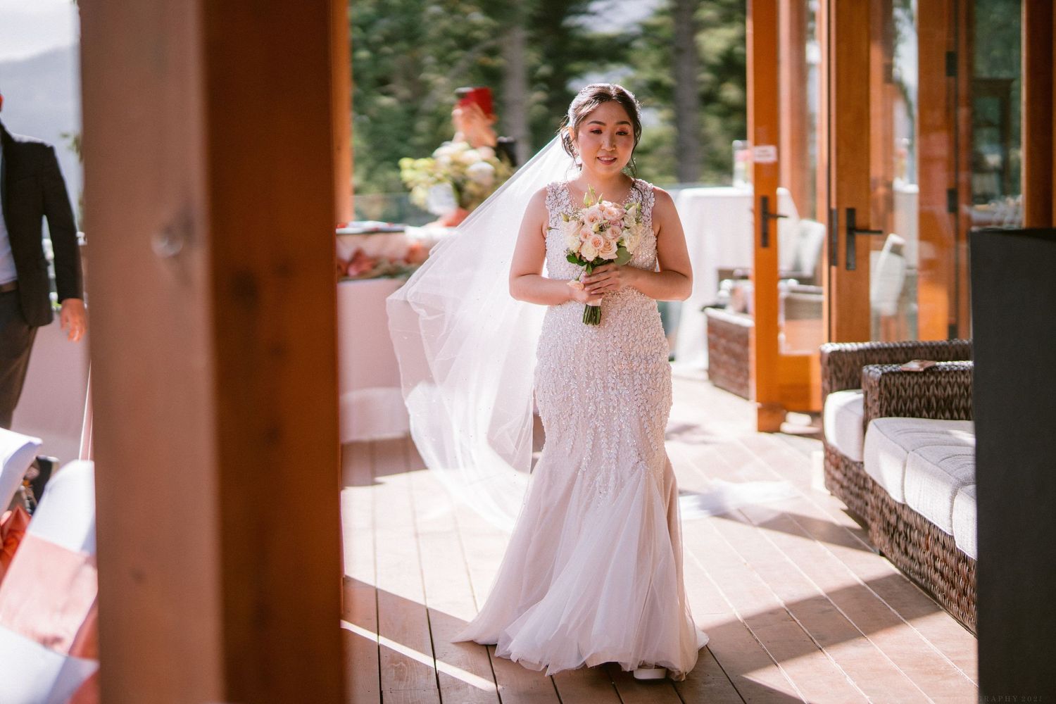 Multiple shots of a bride in white dress walking through a sunlit wooden porch.
