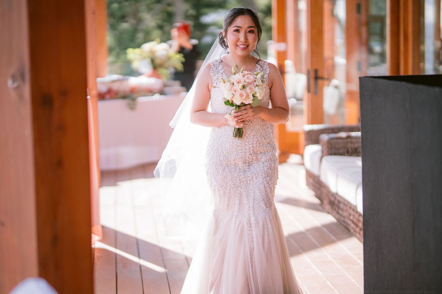 Wedding celebration on an outdoor deck with scenic mountain views in the background.