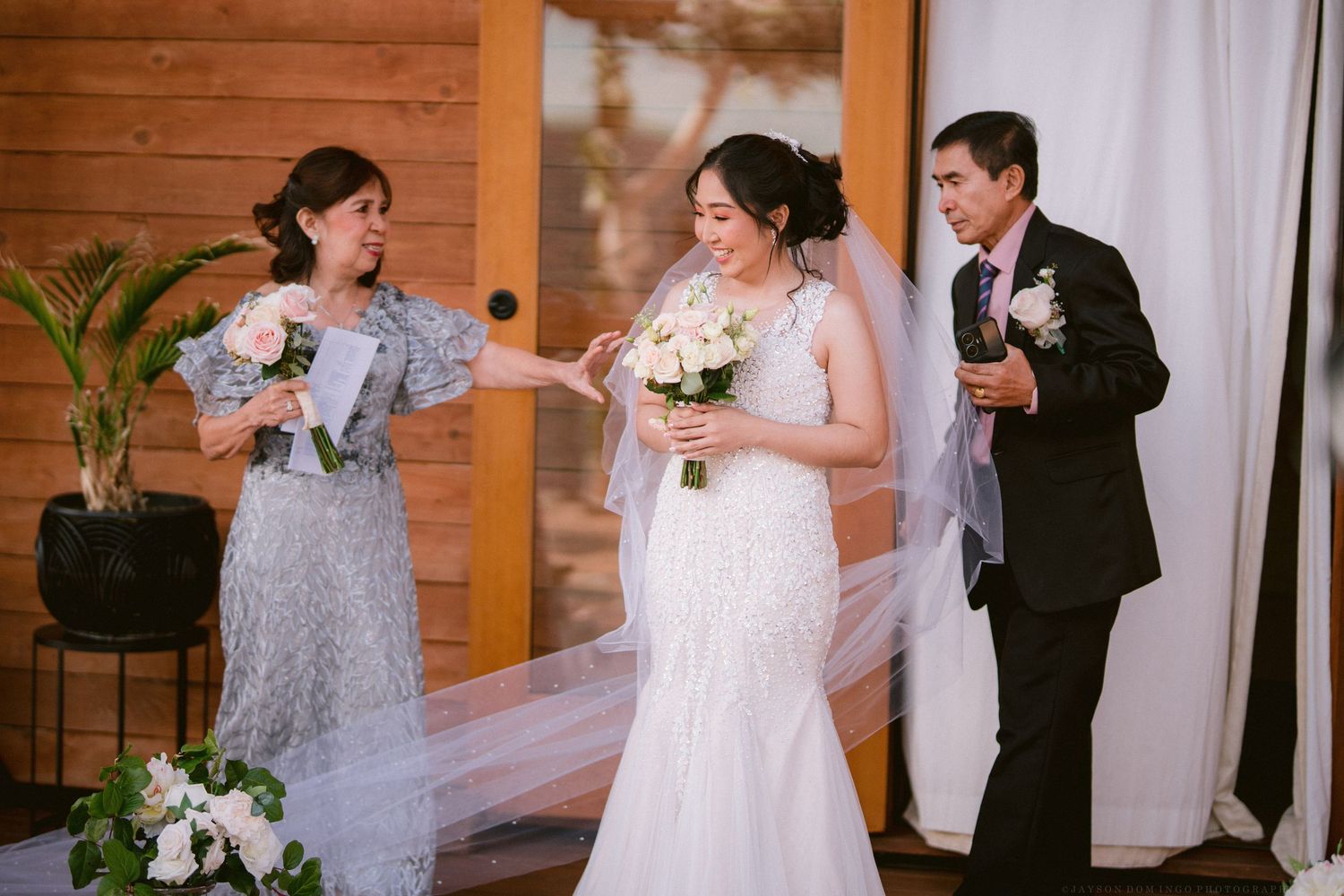 Wedding celebration in rustic wooden venue with elegant decor and floral arrangements.