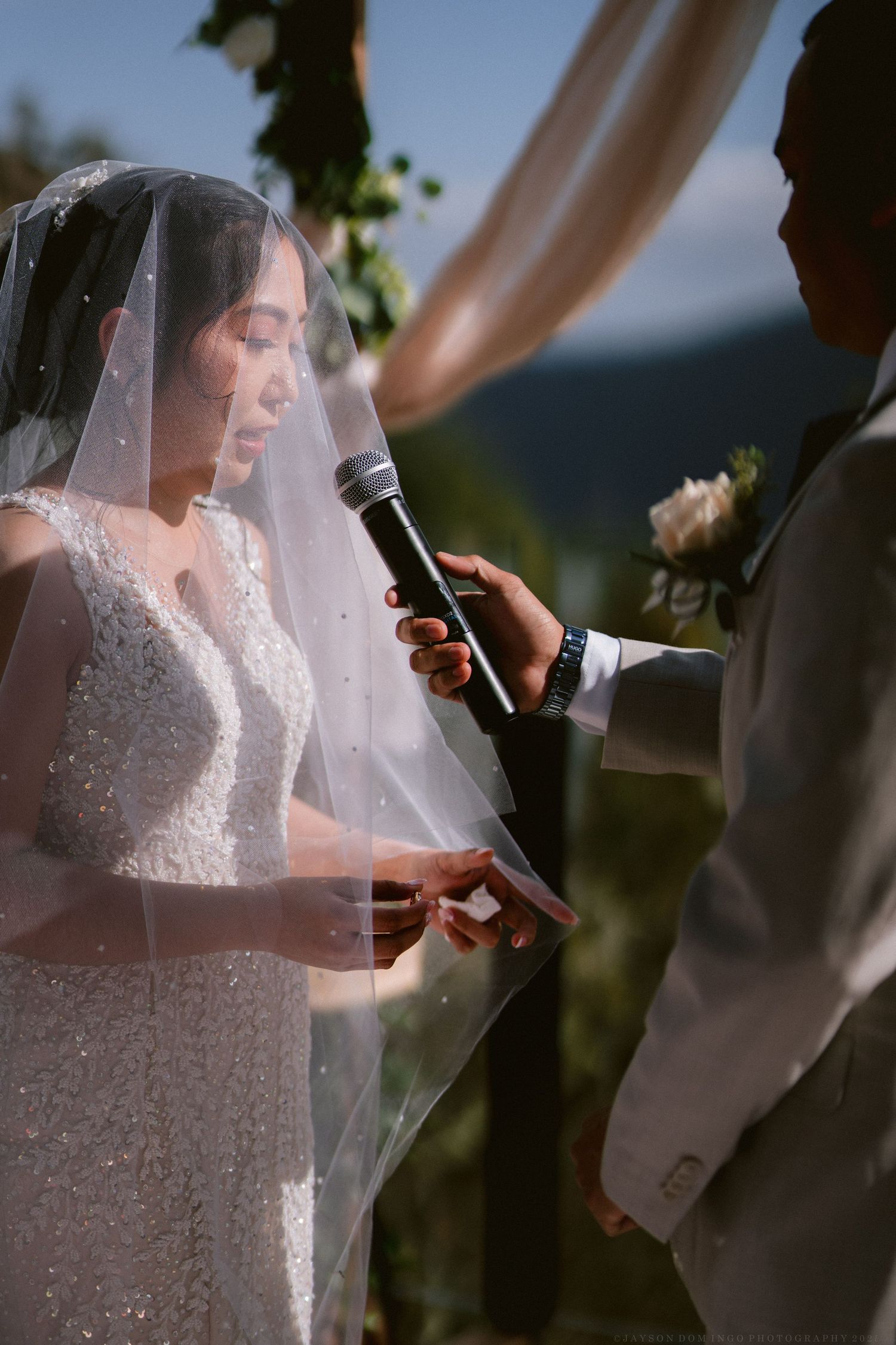 An intimate outdoor wedding ceremony with mountain scenery.