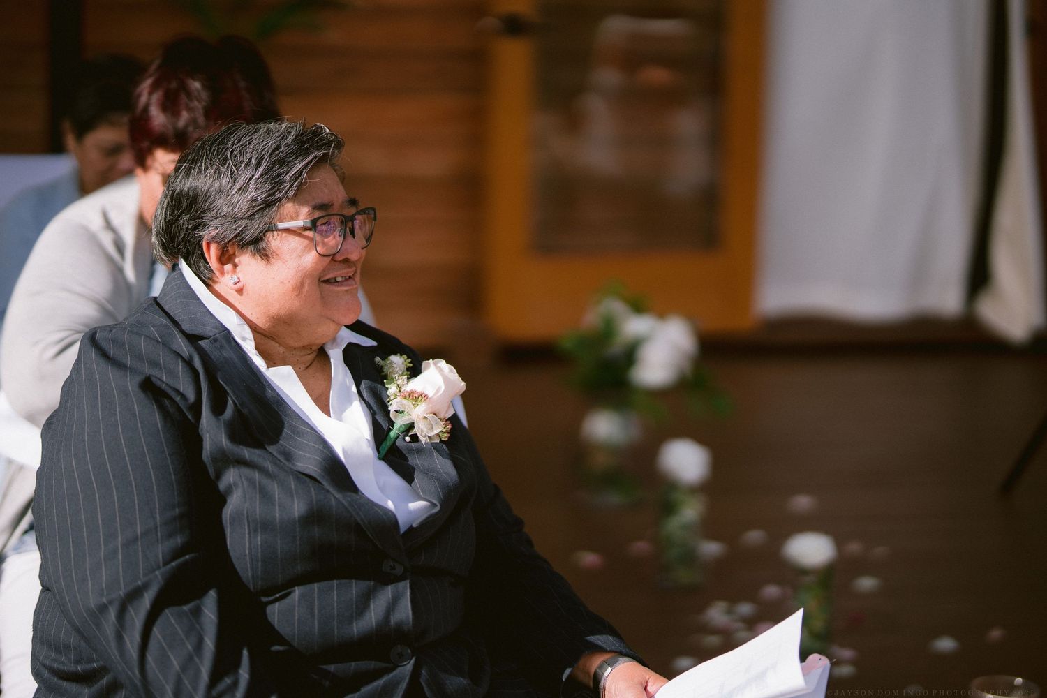 Wedding reception venue with wooden interior and ambient lighting creating a warm atmosphere.