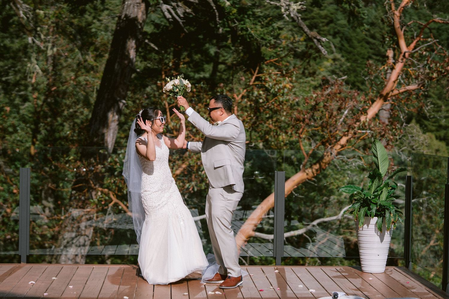Wedding couple dancing outdoors in a scenic mountain setting during golden hour.