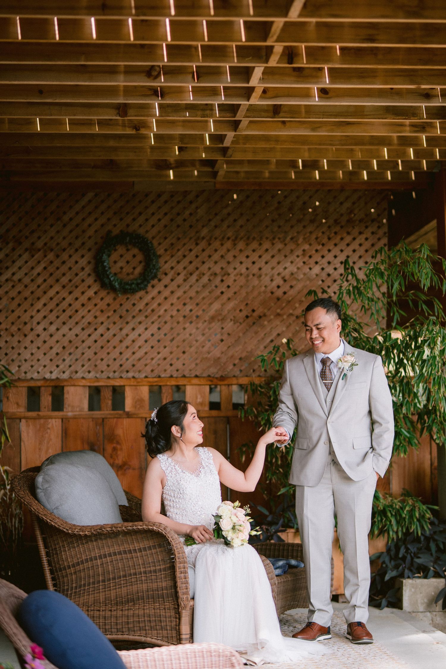 Couple shares intimate moment under wooden beamed ceiling in rustic indoor setting.