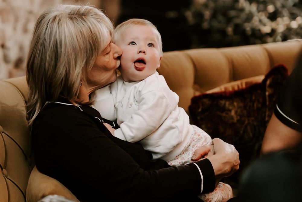 A tender moment captured between family members in a warm, intimate setting.