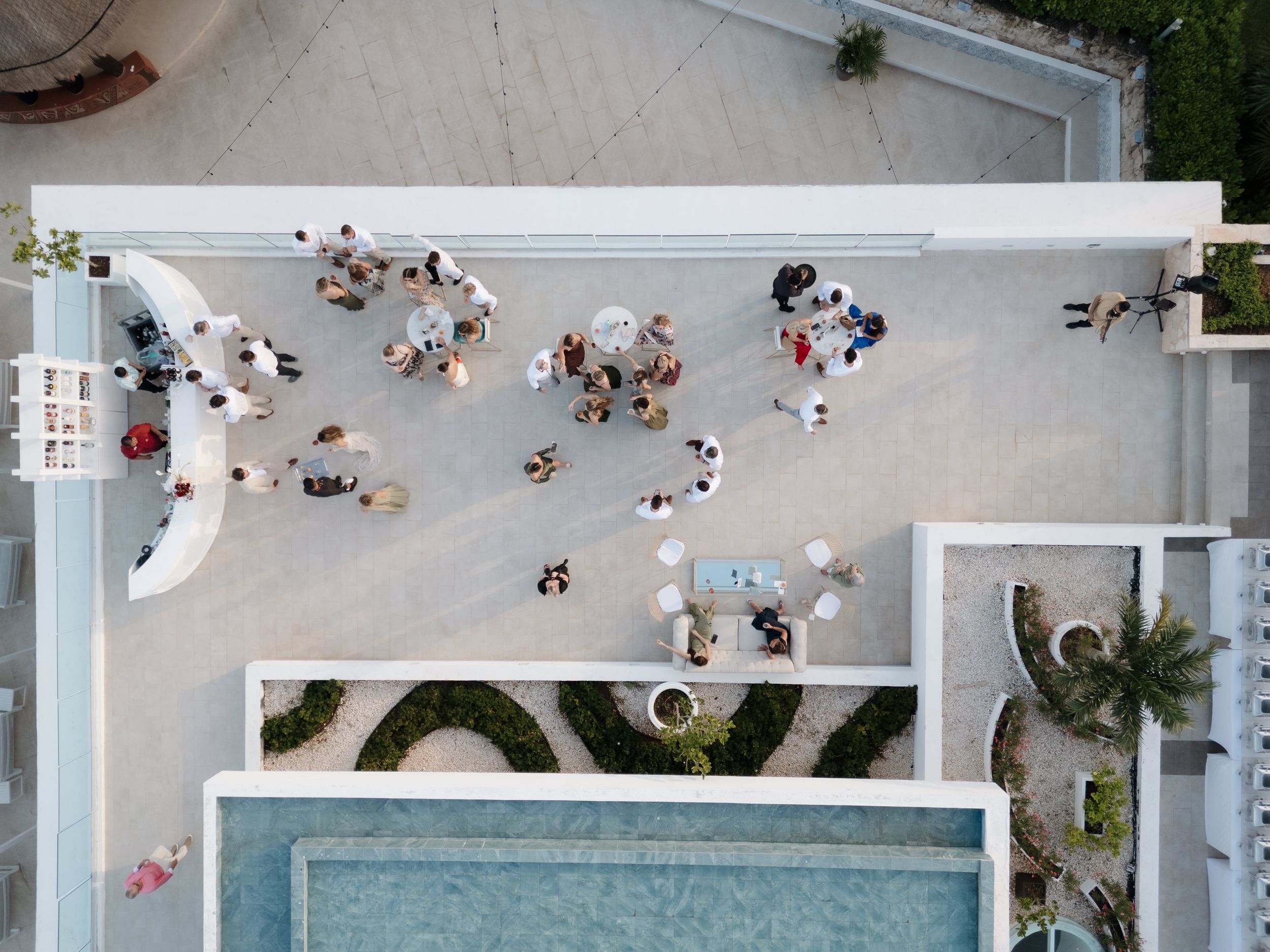 Drone view of wedding cocktail hour at Majestic Elegance Costa Mujeres with guests enjoying drinks – destination wedding Mexico