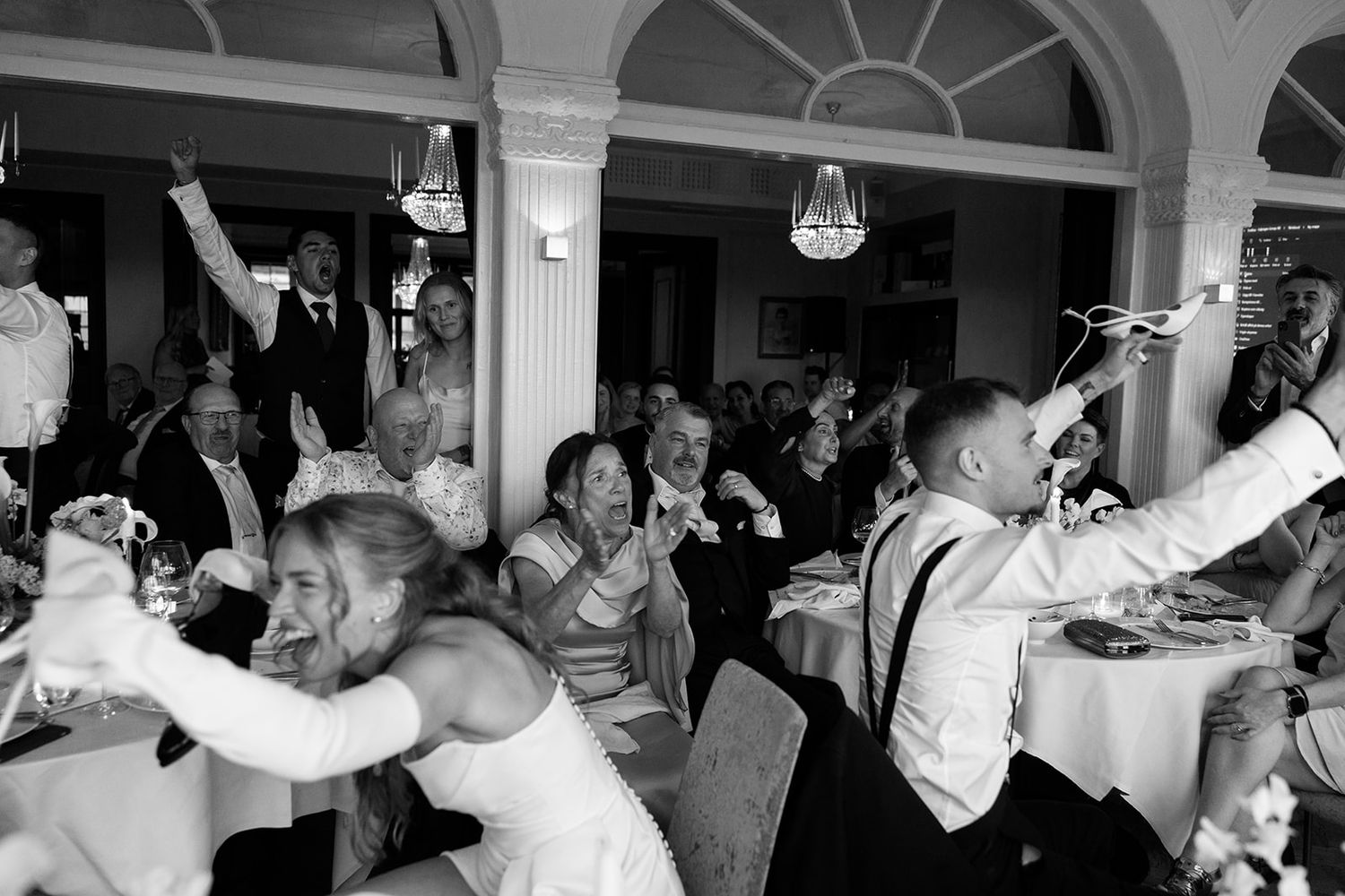 A collage of black and white photos showing people dancing and celebrating at what appears to be a wedding reception.