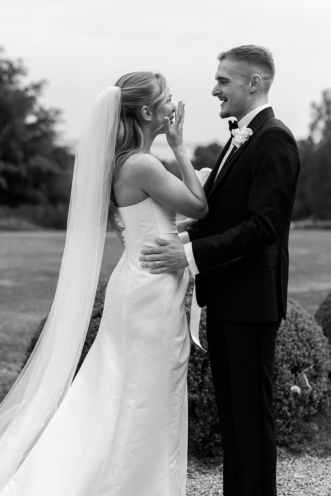 Black and white wedding photo sequence showing tender moments between newlyweds during their first look outdoors.