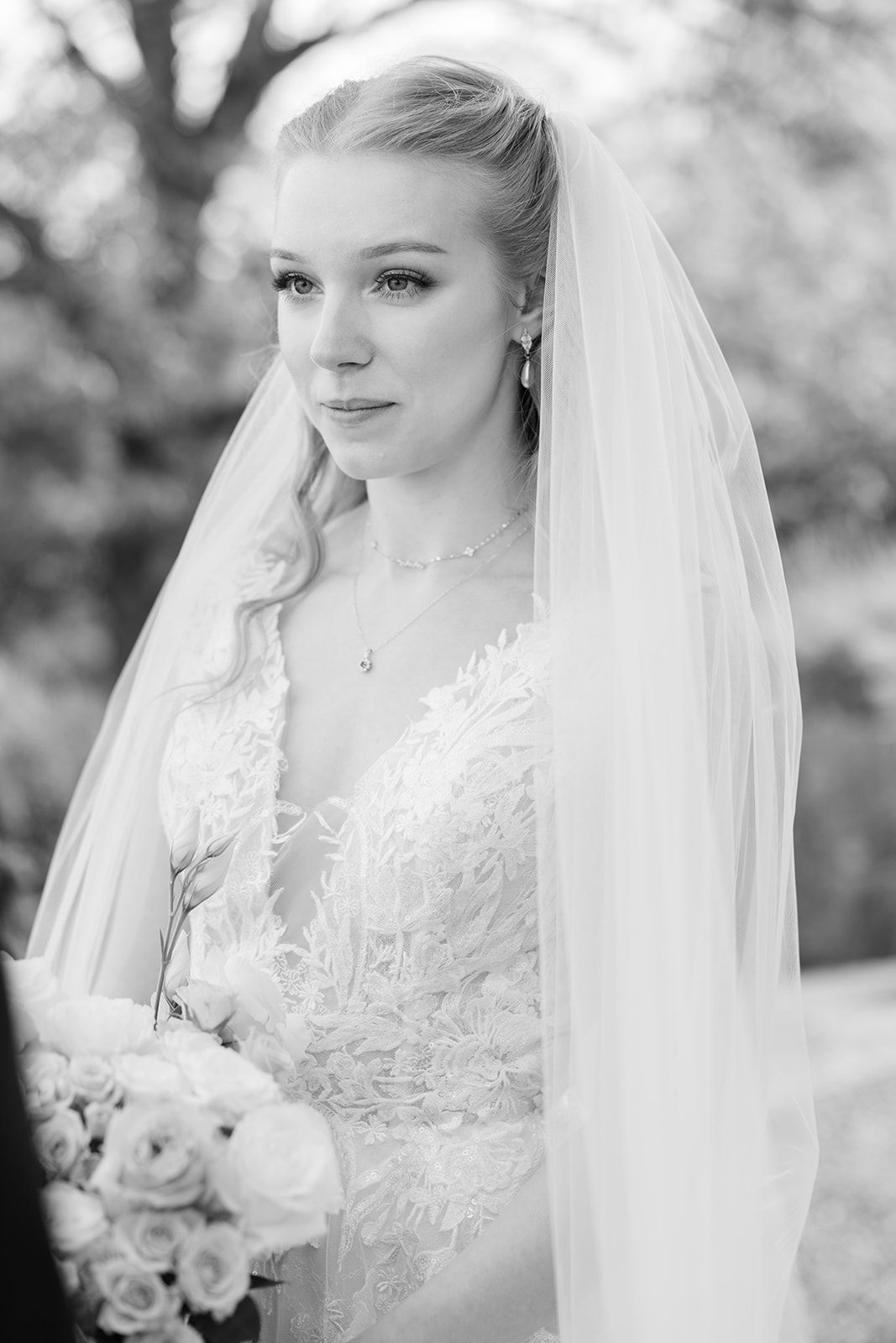 Black and white bridal portrait series showing elegant lace wedding dress details and flowing veil.