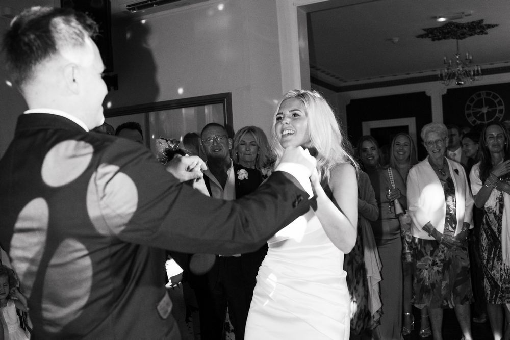 A black and white photo montage shows people dancing and celebrating at what appears to be a wedding reception.