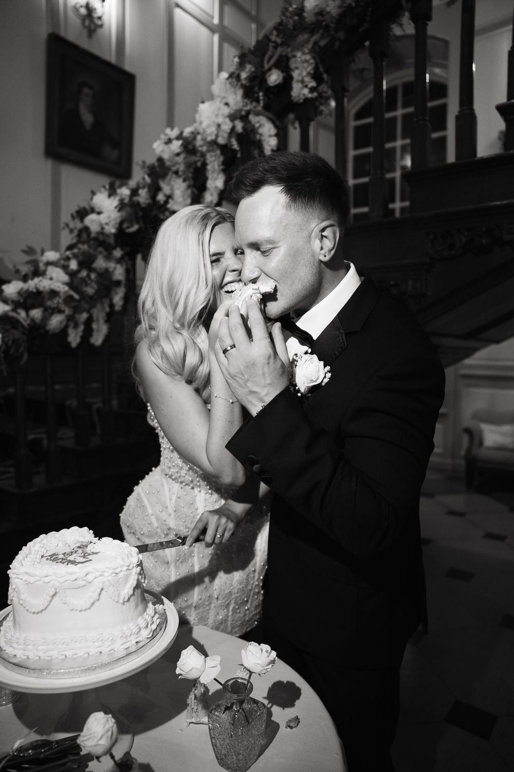 Black and white wedding photo sequence showing newlyweds sharing cake and romantic moments at their reception.