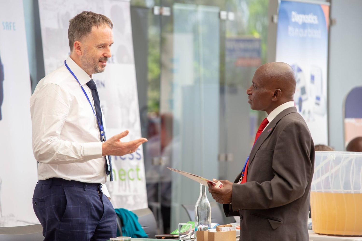 Two business professionals engaged in animated conversation at a networking event or conference.