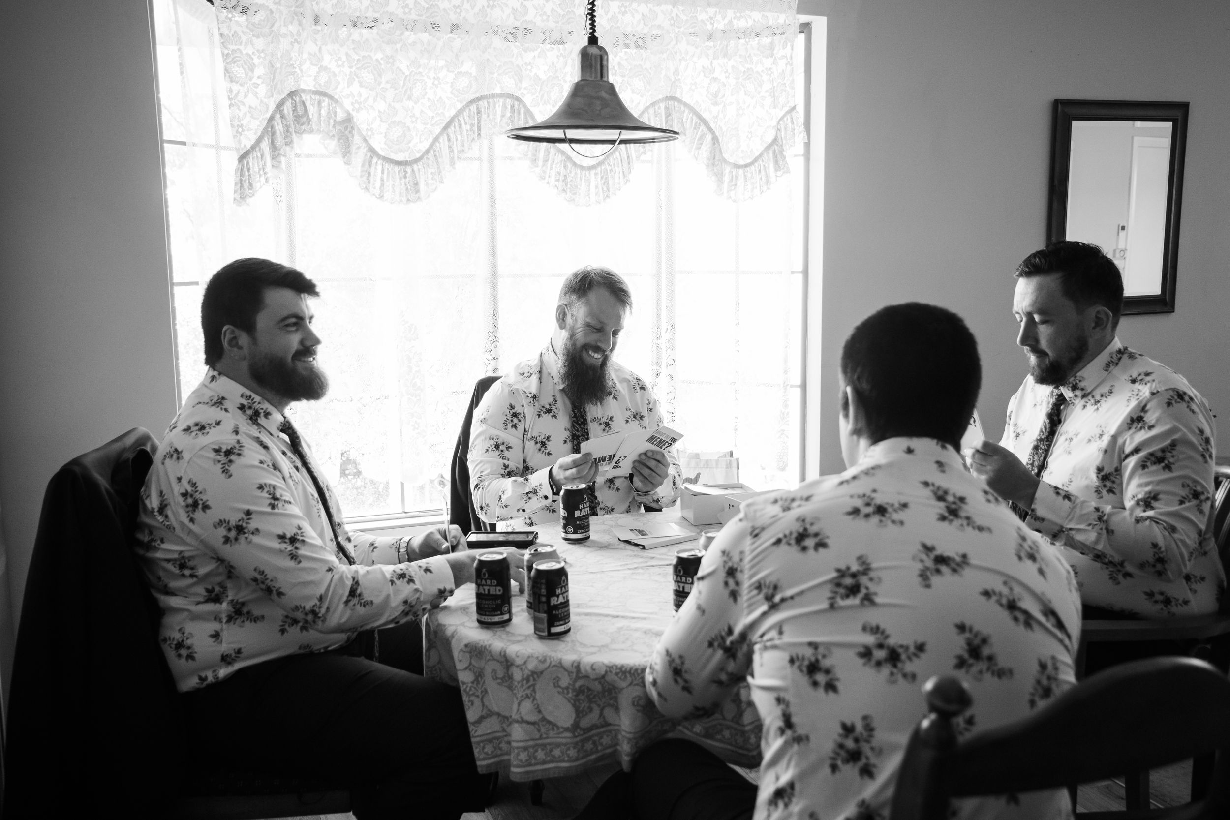 Groom prep photography, groomsmen playing board games before getting ready in a vintage styled kitchen