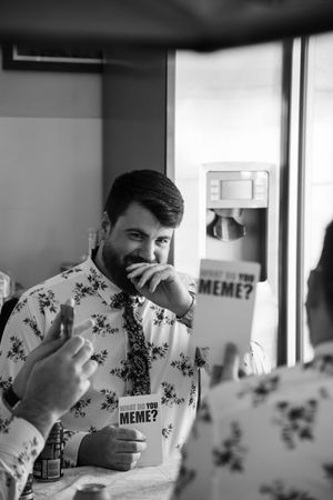 A series of candid black and white shots showing groom playing board games with his groomsmen before the ceremony