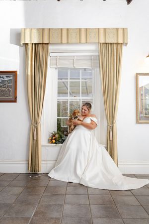 bridal portrait of bride and her dachshund in a vintage room. Wedding photography perth