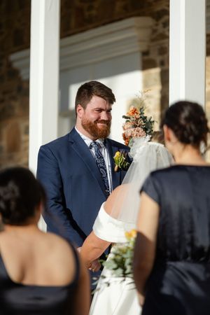 A wedding couple shares an intimate moment together during their ceremony.