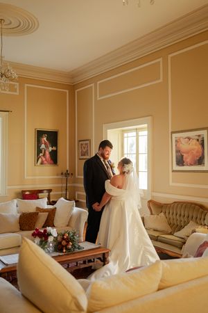 Elegant cream-colored bridal suite, Bride and groom sharing an intimate moment couples photography