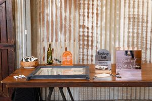 Wedding favors and decorative jars arranged neatly on wooden shelves with string lights creating a warm ambiance.