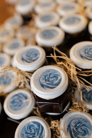 Close-up view of decorative blue and white mason jar lids with twine accents arranged in rows.