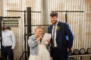 A couple share a joyful moment together during their industrial-style wedding celebration.