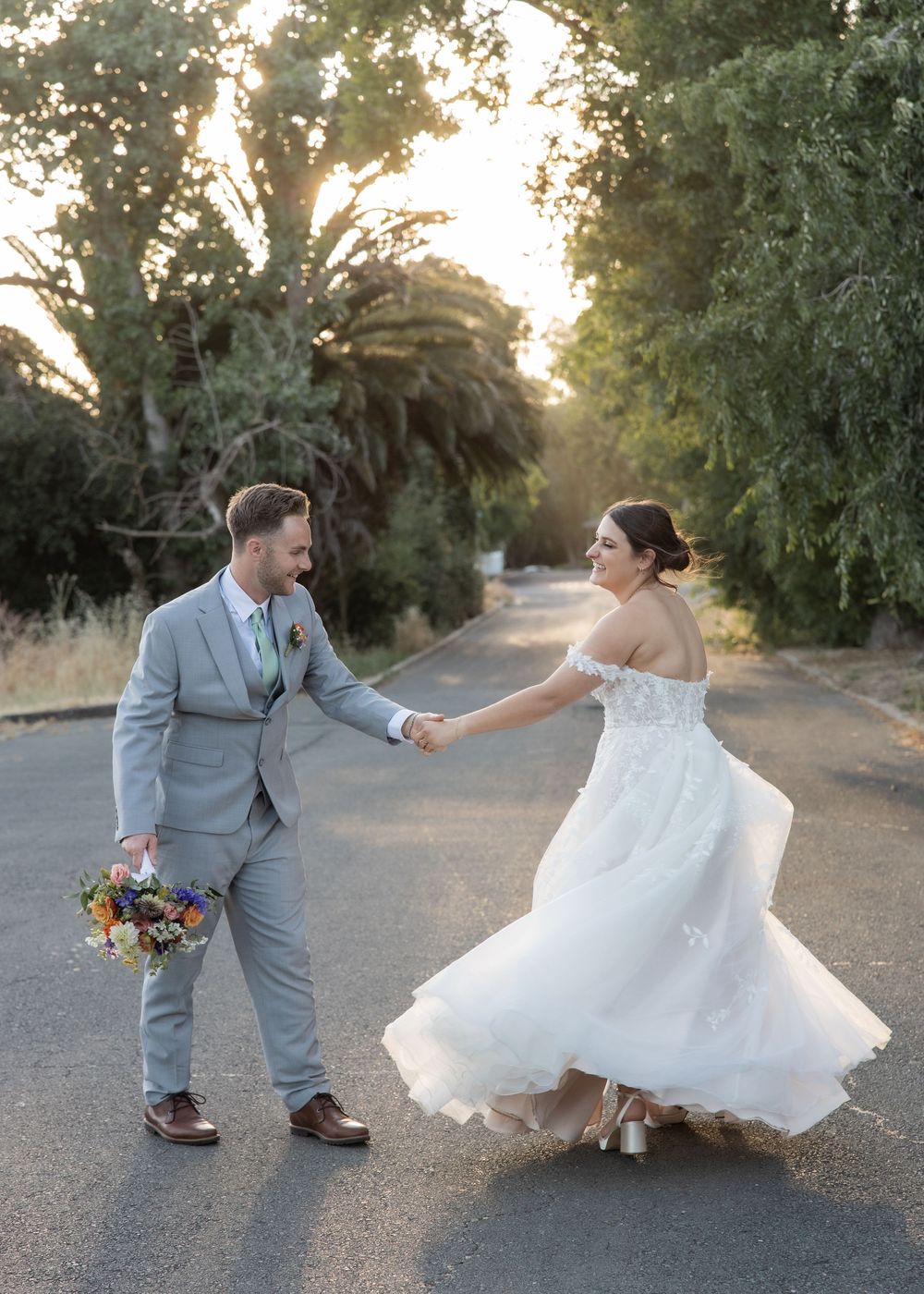 Couple walking along the tree-lined road outside Jefferson Street Mansion