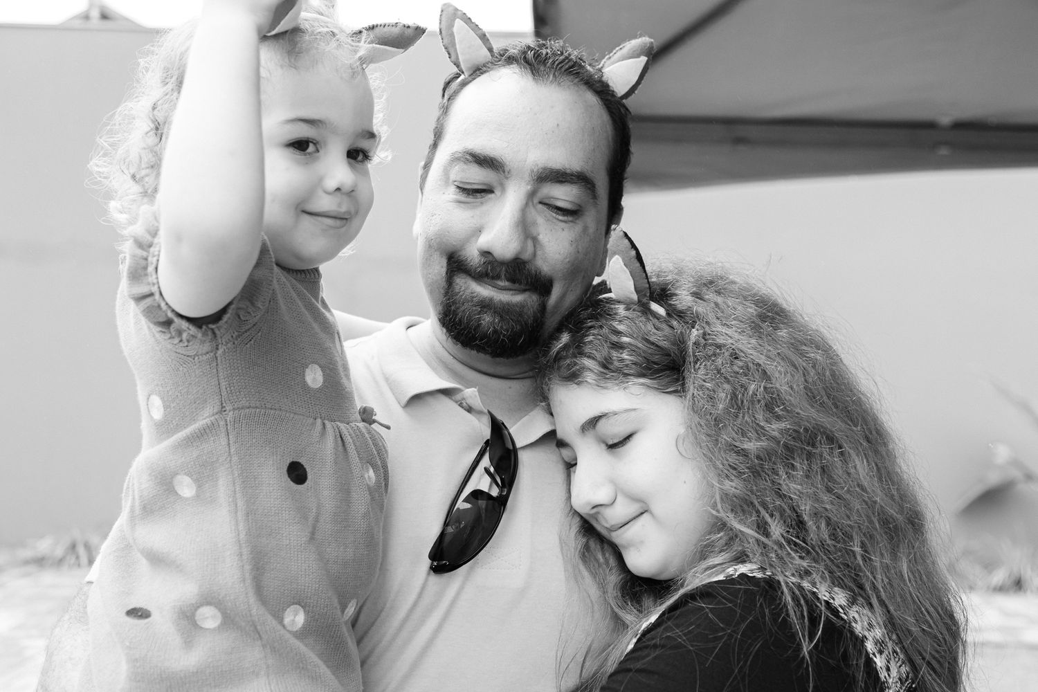 Black and white collage showing tender family moments and interactions between adults and children in various settings.