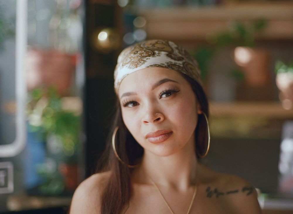 Group of lifestyle photos showing someone wearing headphones and hoop earrings in different casual poses and expressions.