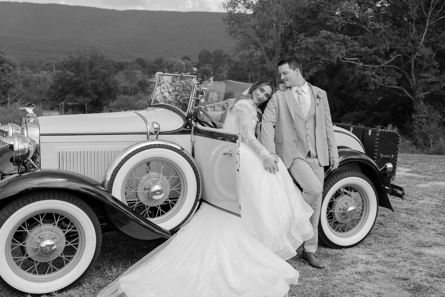 Wedding couple posing with vintage car in classic black and white photography Chattanooga Wedding Photographer