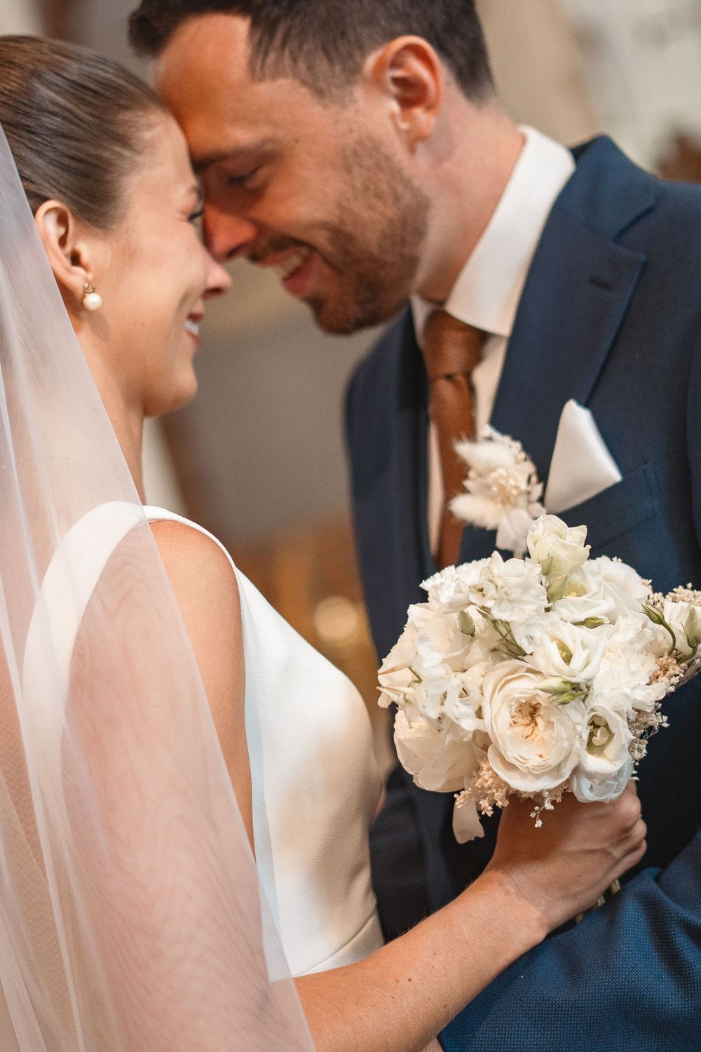 A romantic series of wedding photos showing tender moments between a bride and groom with delicate white bouquets.